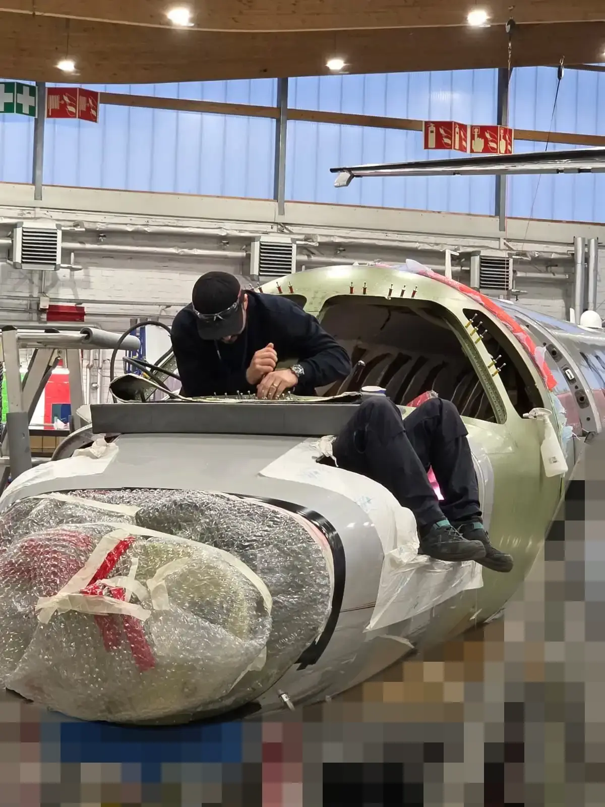 Mr. D. working on the nose section of a business jet in the hangar